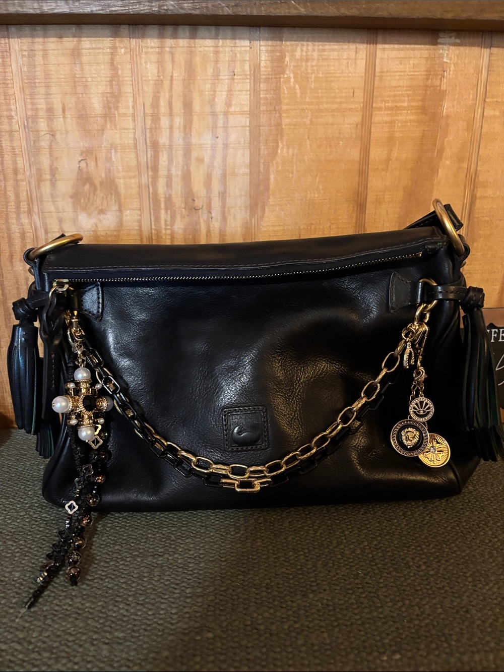Dooney & Bourke Black Leather Women’s Shoulder Bag with Chain Accents & charms.